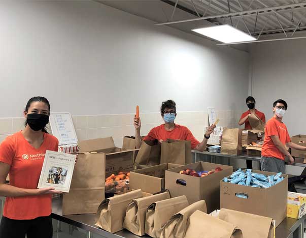 Volunteers sorting through boxes of food.